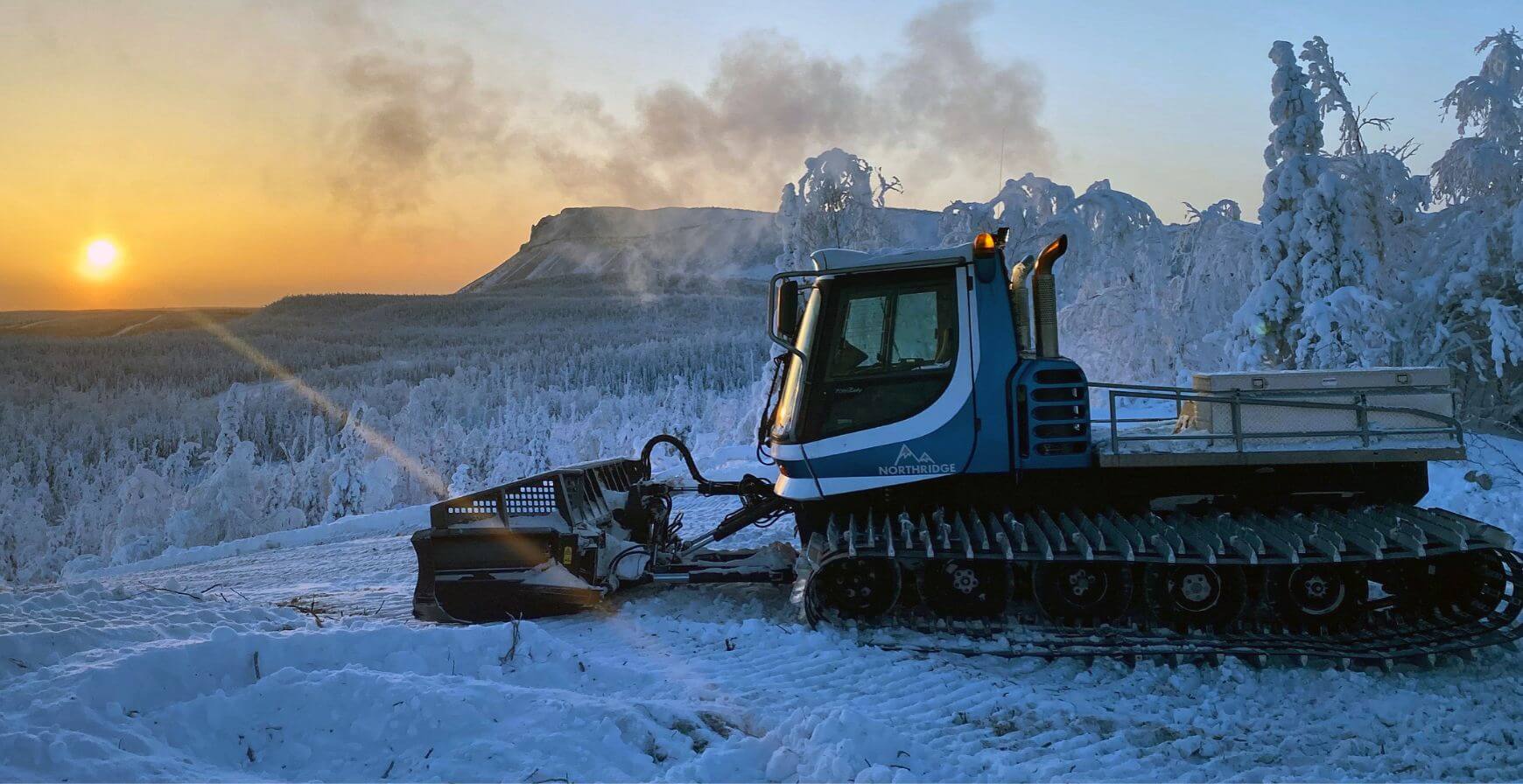 Snow cat at sunset